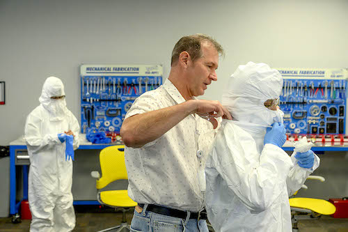 Technicians suit up in class