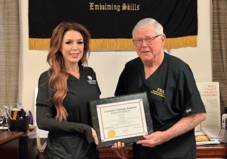 Jamie Thompson and Vernie R. Fountain pose with Jamie's Fountain National Academy certificate of completion
