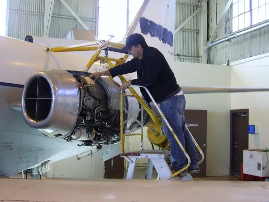 A CGCC Aircraft Maintenance student working on a part of a plane during class.